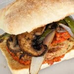Delicious spicy chicken burger topped with harissa, eggplant, mushrooms, and onions.